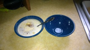 A bowl filled with food next to another empty bowl.