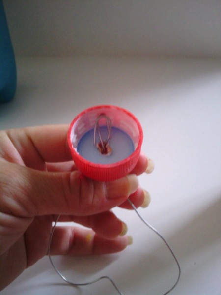 Soda Bottle Bird Feeder - poke a hole in the center of the cap and add wire hanger