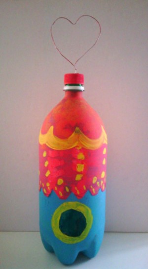 Soda Bottle Bird Feeder - finished bottle with more decorative painting and ready to hang