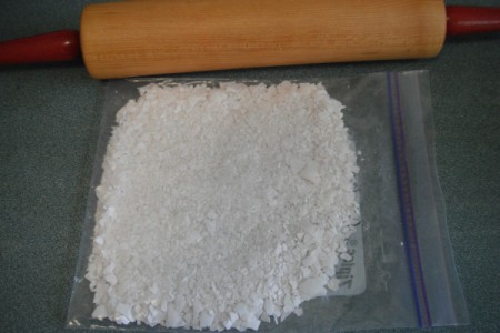 A plastic bag of crushed egg shells and a rolling pin.