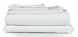 A set of white bedsheets, folded.