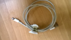 A looped computer cord being held together with a hair clip.