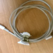 A looped computer cord being held together with a hair clip.