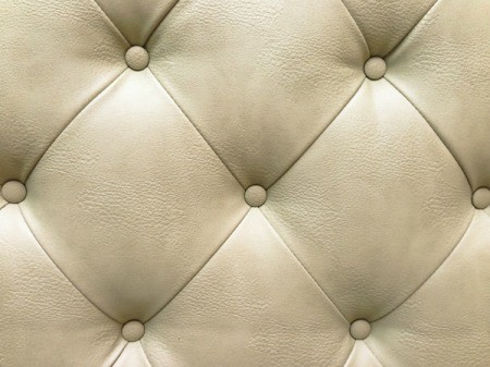 Upholstered cream leather sofa.