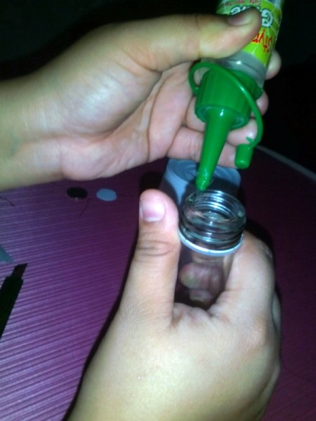 Recycled Noodle Cup Lamp - putting glue on bottle rim