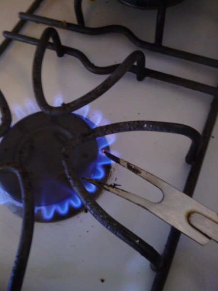 Sumo Wrestler Salt and Pepper Shakers - heating fork over gas stove