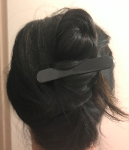 Hair clipped to hold an updo wrap.