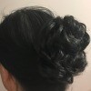 An updo wrap attached to black hair.