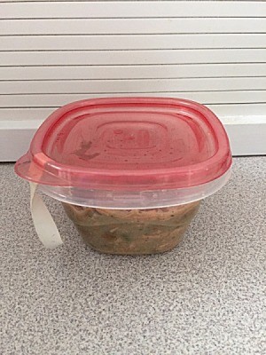 A plastic container with a rubber band sticking out, to help with opening.