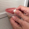 A plastic container with a rubber band sticking out, to help with opening.