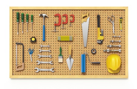 A pegboard with tools hanging on it.