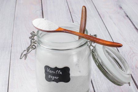A jar of sugar that has been flavored by vanilla beans.