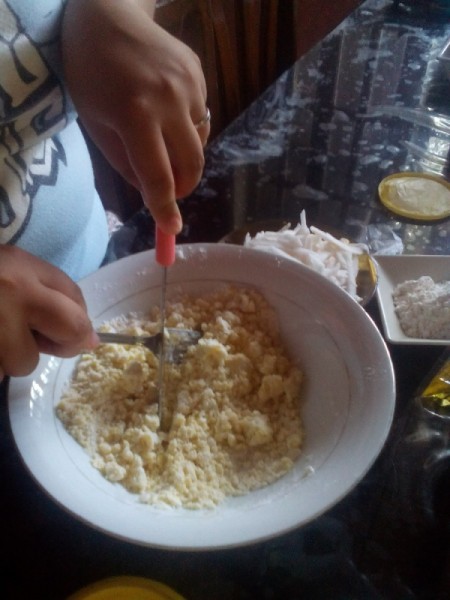 forking butter into flour for dough