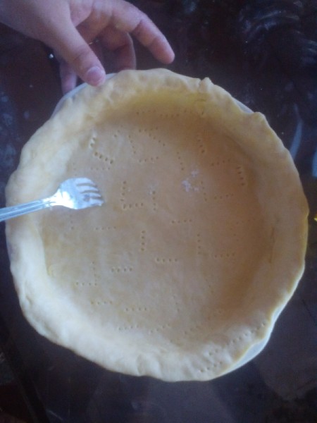 forking Buko Pie dough in pan being poked with fork