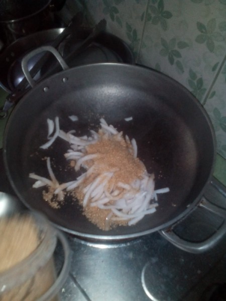thin strips of coconut and sugar in pan