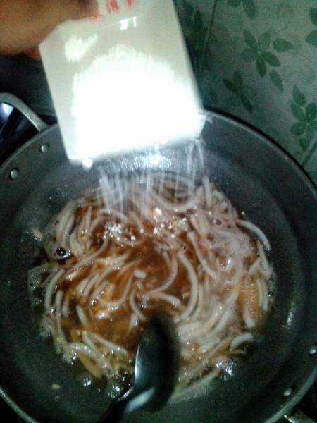 water added to thin strips of coconut and sugar in pan adding corn starch