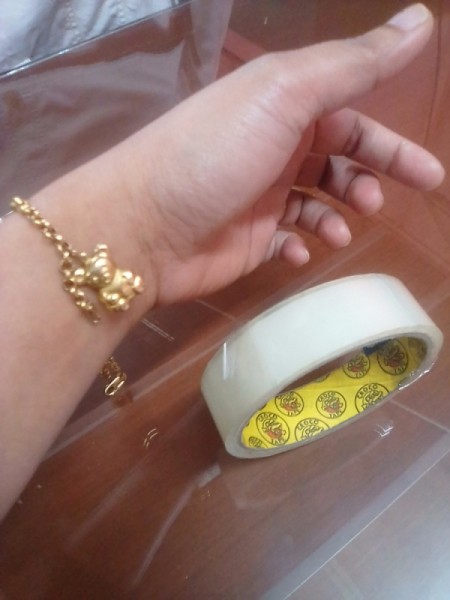 A clasp bracelet and a roll of tape.