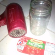 A label removed from a glass jar, next to the jar and a hair dryer.