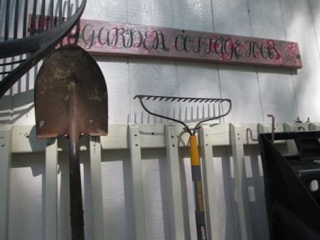 Old Deck Railing Used For Garden Tool Storage - optional sign above hanging tools