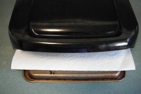 closed grill with paper towel below