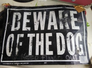 An old metal "Beware of the Dog" sign.