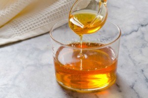 A golden syrup in a clear glass.