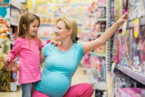 A mom and her daughter shopping for toys.
