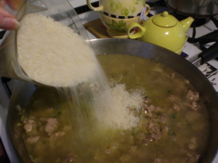 adding rice to pan