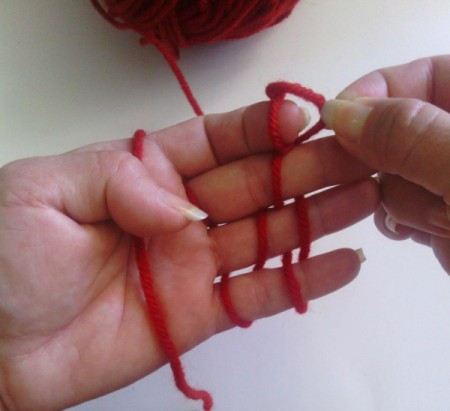 Finger Knit Headband - begin by pulling bottom loop up and over