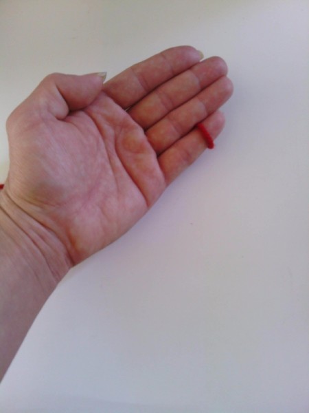 Finger Knit Headband - one loop remaining on pinky finger