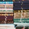 How Many Squares in a Fat Quarter? - stack of fat quarters tied with ribbons