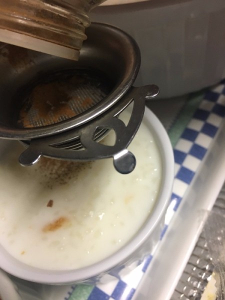 sprinkling cinnamon on Rice Pudding