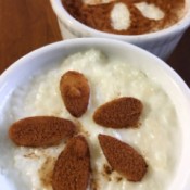 Rice Pudding in cups with cinnamon and almond slices