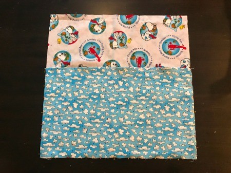 Book Pocket Pillow - place pocket on top of one of the pillow pieces and pin along sides and bottom.