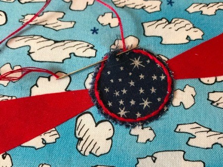 Book Pocket Pillow - using 3 strands of floss add decorative stitching to propeller