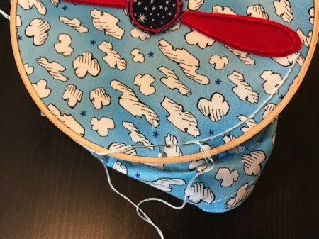 Book Pocket Pillow - use the edges of the embroidery hoop as a guide to stitch some "air turbulence" with embroidery floss (3 strands)