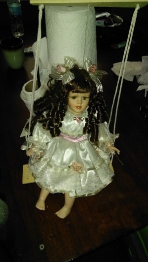 Value of Porcelain Doll and Figurine - doll on swing