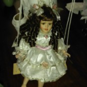 Value of Porcelain Doll and Figurine - doll on swing