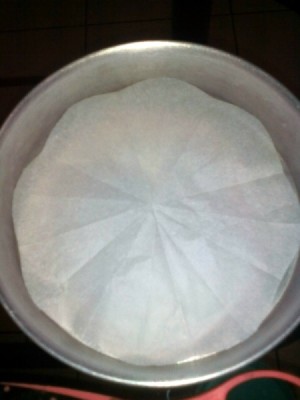 Wax paper cut to fit in a round pan.