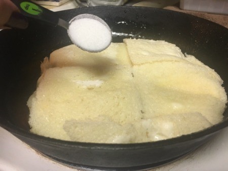 sprinkling sugar on bread