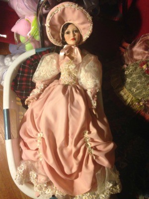 Identifying a Porcelain Doll - doll wearing a fancy dark pink dress