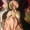 Identifying a Porcelain Doll - doll wearing a fancy dark pink dress