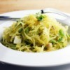 A plate of spaghetti squash with herbs and cheese.