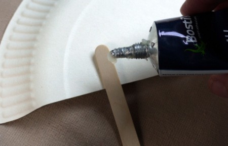 Paper Plate Fan - glue 2 Popsicle sticks to back at an angle