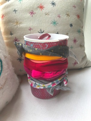 Repurposing Yogurt Container for Bow/Headband Storage - headbands wrapped around contains