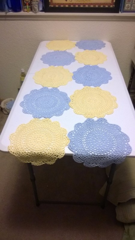 Table Cover Using Store Bought Doilies - lay the two sets of 5 dollies next to each other with a tip in between two on the opposing doily right side down, tie as before and turn right side up