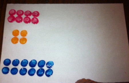 Painted Lego Math - stamping a page for teaching addition with multiple sets of two