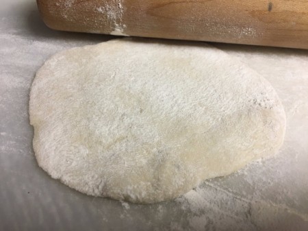 Flatbread flattened on mat