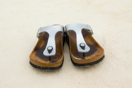 A pair of well worn Birkenstock brand sandals.