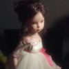 Identifying a Porcelain Doll - doll wearing a white dress with pink trim